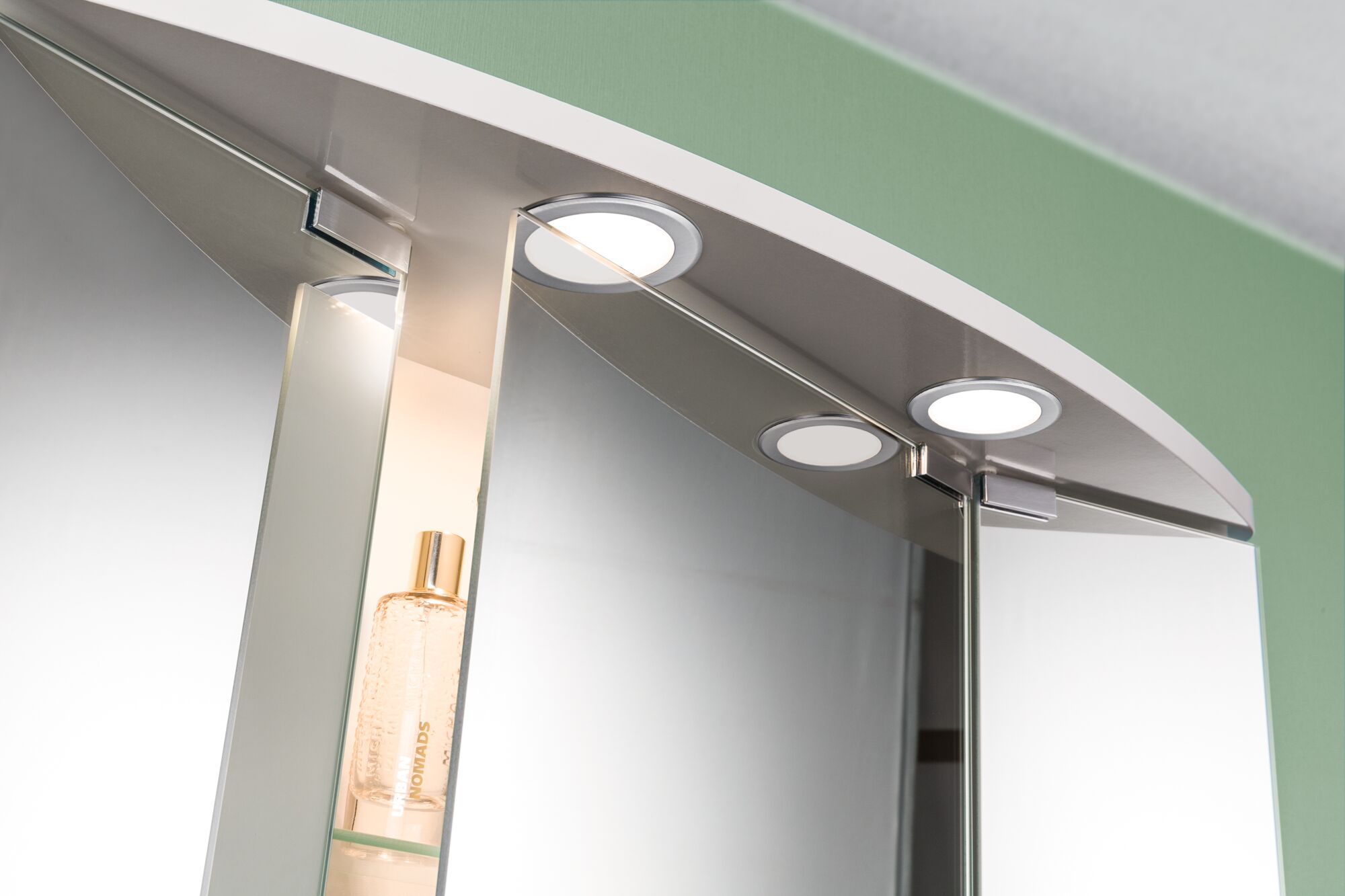 Round LED bathroom mirror light with silver frame and built-in cabinet with glass shelf.
