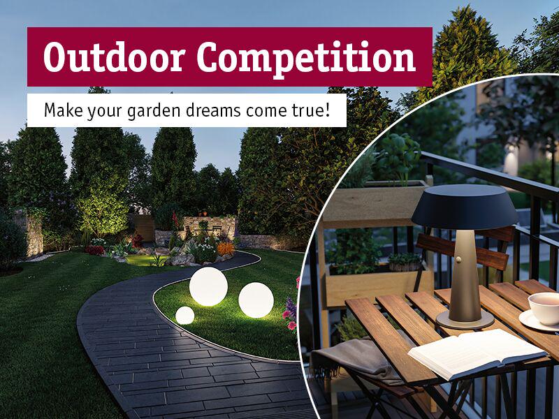 Garden path with round white LED lights and modern outdoor table lamp on wooden terrace at dusk