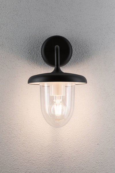 Sort væglampe med klart glas og synlig LED-pære til moderne indendørs belysning.