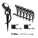 Ensemble de six projecteurs LED noirs pour jardin avec piquets et câbles de connexion pour éclairage extérieur.