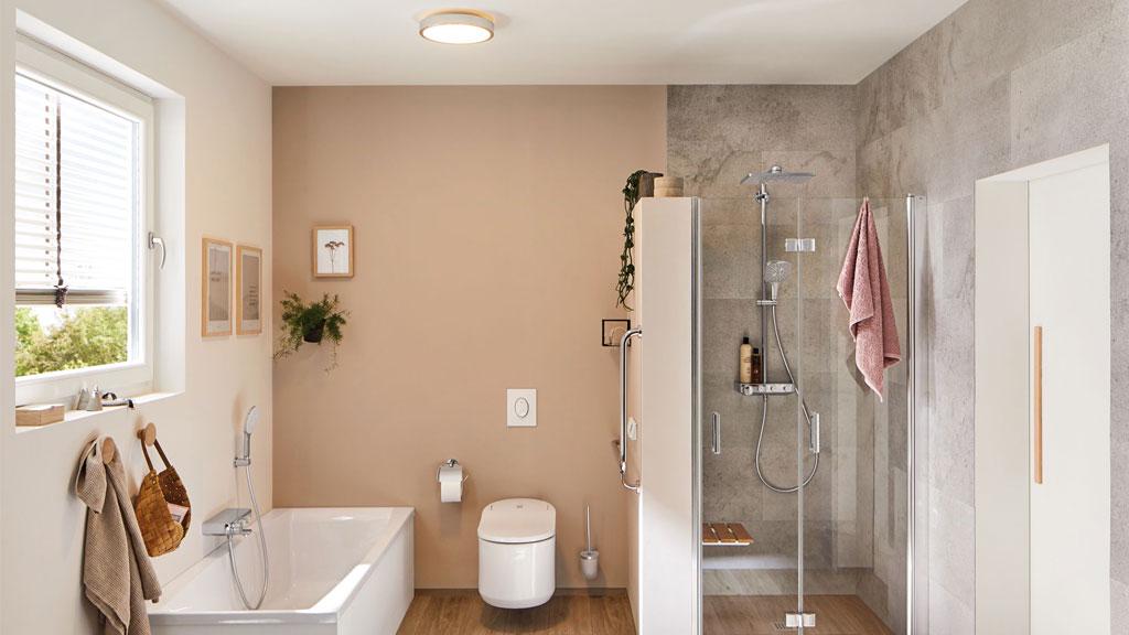 Modern bathroom with white bathtub, glass shower, and round wooden ceiling light for bathroom lighting.