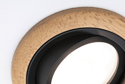Round LED recessed light with natural wood frame and black inner ring for modern interiors
