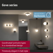 Gove series bathroom lights with matte brown mounts and white globe shades for elegant bathroom lighting