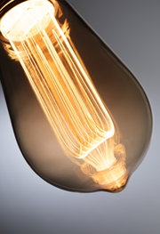 Close-up of warm white LED bulb with clear glass for decorative lighting and energy efficiency