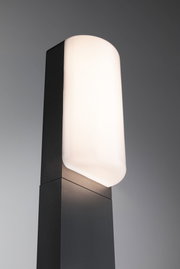 Modern outdoor light with black metal housing and white opal glass for garden lighting.