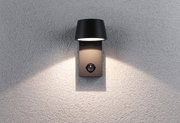 Black metal outdoor wall light with motion sensor on grey wall for garden lighting