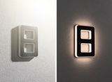 Modern rectangular LED wall light in white and black with indirect lighting effect.