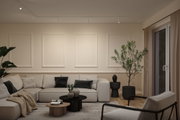 Modern living room with beige sofa, black accents, and minimalist ceiling lights creating a cozy atmosphere