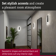Modern hallway with geometric black and white metal wall lights creating stylish room accents