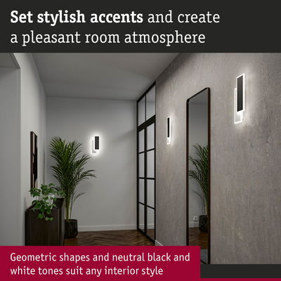 Modern hallway with geometric black and white wall lights and large mirror creating stylish room accents