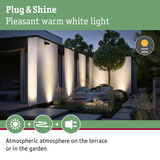 Modern outdoor lighting with warm white light on house wall and terrace creating atmospheric garden illumination