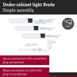 White Bredo under-cabinet lights with black ends, including power adapter and plug connections for easy installation