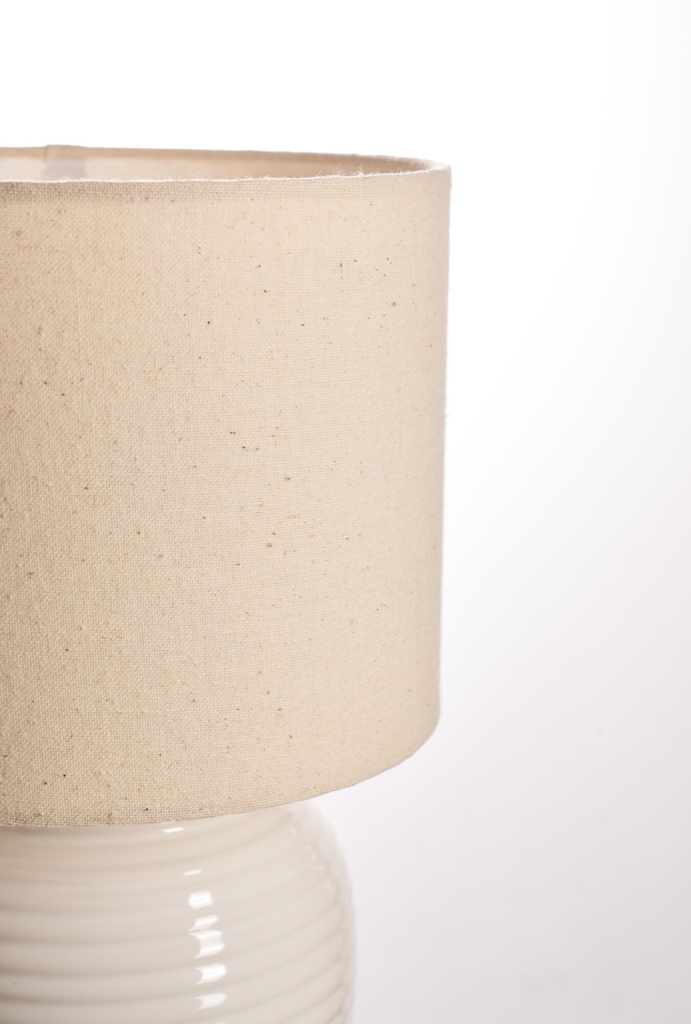 Beige linen lampshade with cream ceramic base for elegant home lighting and decor