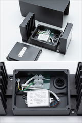 Black aluminium housing with open LED driver and terminal block for outdoor light fixture