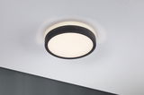 Round ceiling light with black fabric edge and warm white light for modern interiors