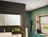 Modern round ceiling lights with white diffuser and gold trim in green bathroom with window seat and mirror.