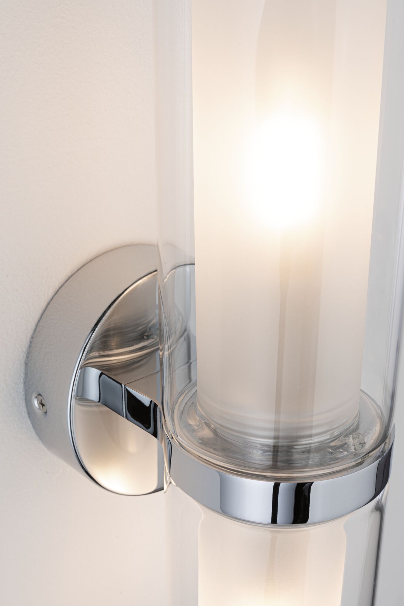 Modern chrome wall lamp with cylindrical glass and warm white LED light for indoor lighting