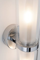 Modern chrome wall lamp with cylindrical glass and warm white LED light for indoor lighting