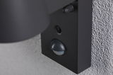 Black outdoor wall light with motion sensor made of metal on grey wall for energy-saving lighting