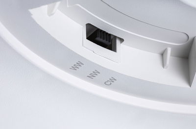 White plastic switch with three settings for light colors WW, NW, and CW for LED lighting control