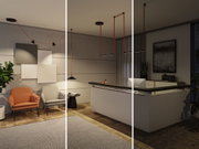 Moderne woonkamer met zwarte LED-plafondlampen aan rode kabels en comfortabele fauteuils