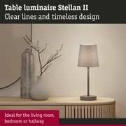 Stellan II table lamp with grey fabric shade and metal base on wooden sideboard in living room