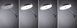 Lampadaire noir moderne avec diffuseur rond en plastique affichant différentes couleurs de lumière.