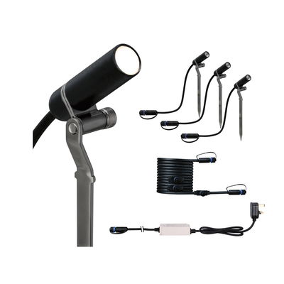 Black LED outdoor spotlight set with ground stakes, cable, and power supply for garden lighting.