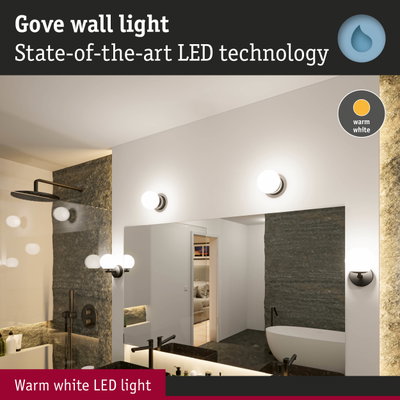 Gove wall light with warm white LED in modern bathroom featuring black fixtures and bathtub