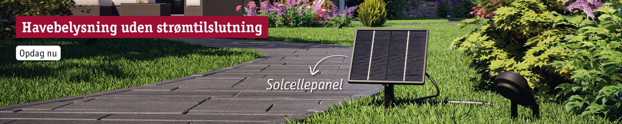 Sort solpanel ved havegang med grøn græsplæne og buske til udendørs belysning