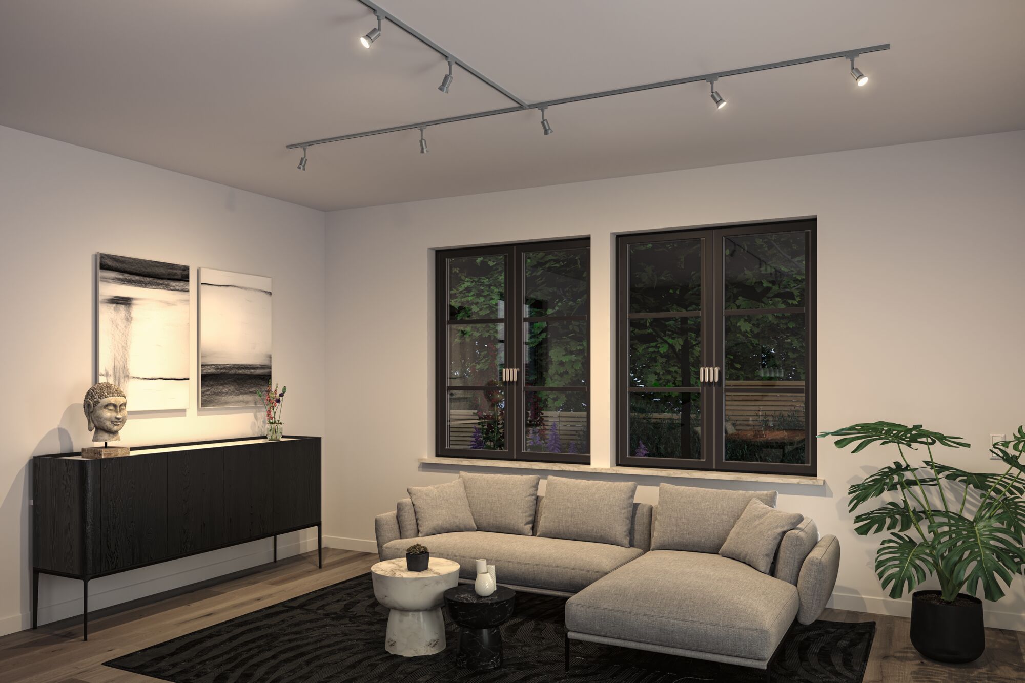 Salon moderne avec canapé en tissu gris, buffet noir et spots de plafond réglables gris.