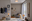 Modern living room with grey armchair, wooden ceiling light, table lamp, bright decor and large window.