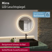 Runder Mirra LED Leuchtspiegel mit warmweißem Licht und schwarzem Waschbecken im modernen Badezimmer.