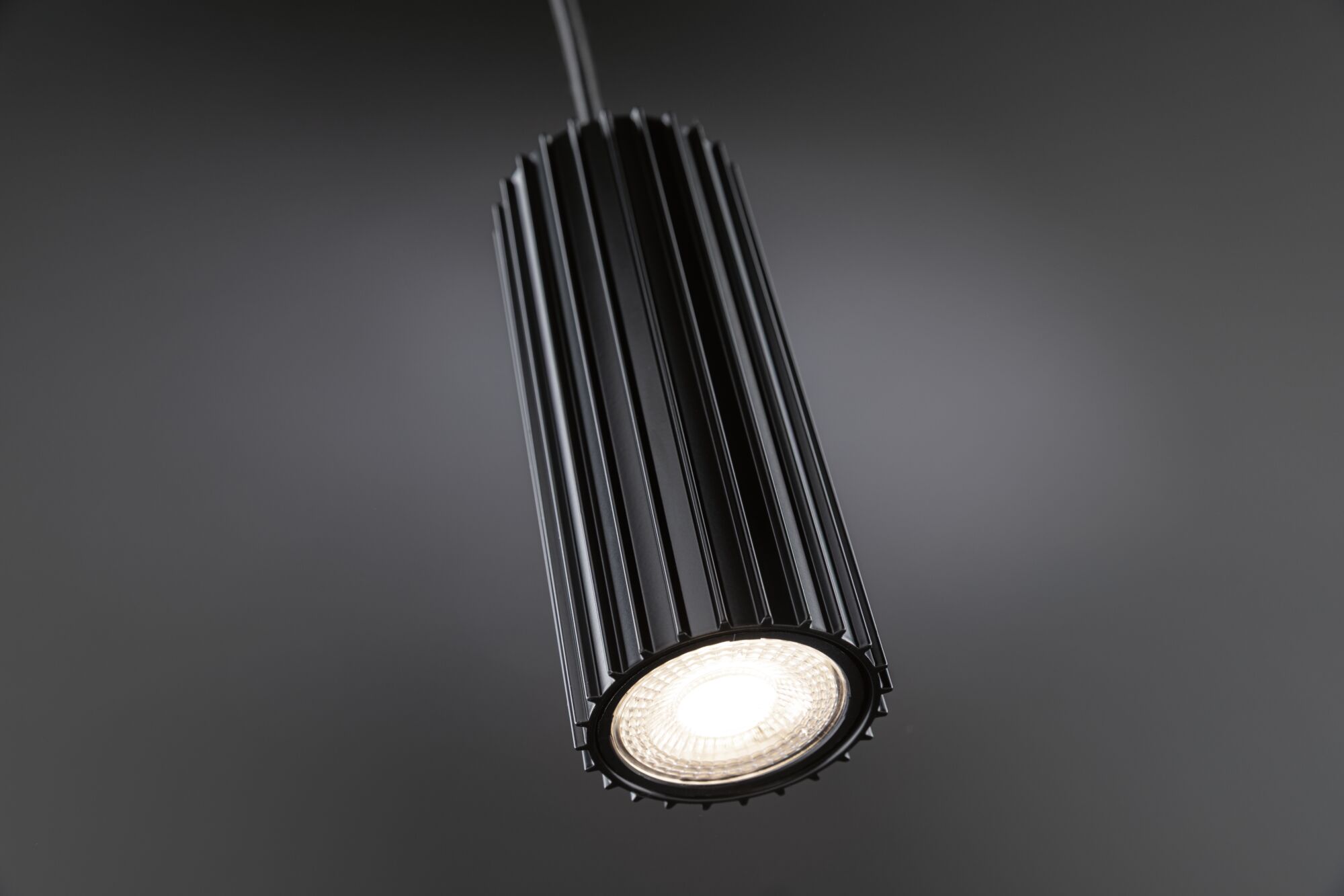 Black aluminium pendant light with ribbed design and warm white LED for modern interior lighting