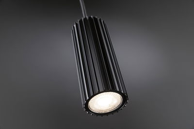 Black aluminium pendant light with ribbed design and warm white LED for modern interior lighting