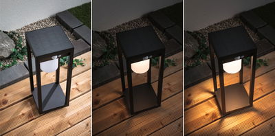 Black solar garden light with motion sensor on wooden deck, showing LED light off and on states for outdoor lighting