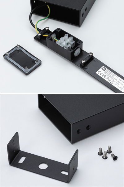 Black metal housing with terminal block and mounting bracket including screws for LED lighting fixture