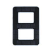 Black plastic panel with rectangular cutouts and fine lines for electronic device components