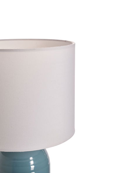 Bordlampe med hvid stofskærm og blå keramisk fod til elegant belysning i hjemmet