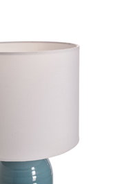 Table lamp with white fabric shade and blue ceramic base for elegant home lighting