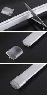 White plastic LED light strip with removable end caps and scissors for cutting to size