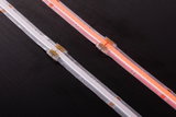 Two LED light strips in white and red with transparent connectors on black surface, LED lighting detail.