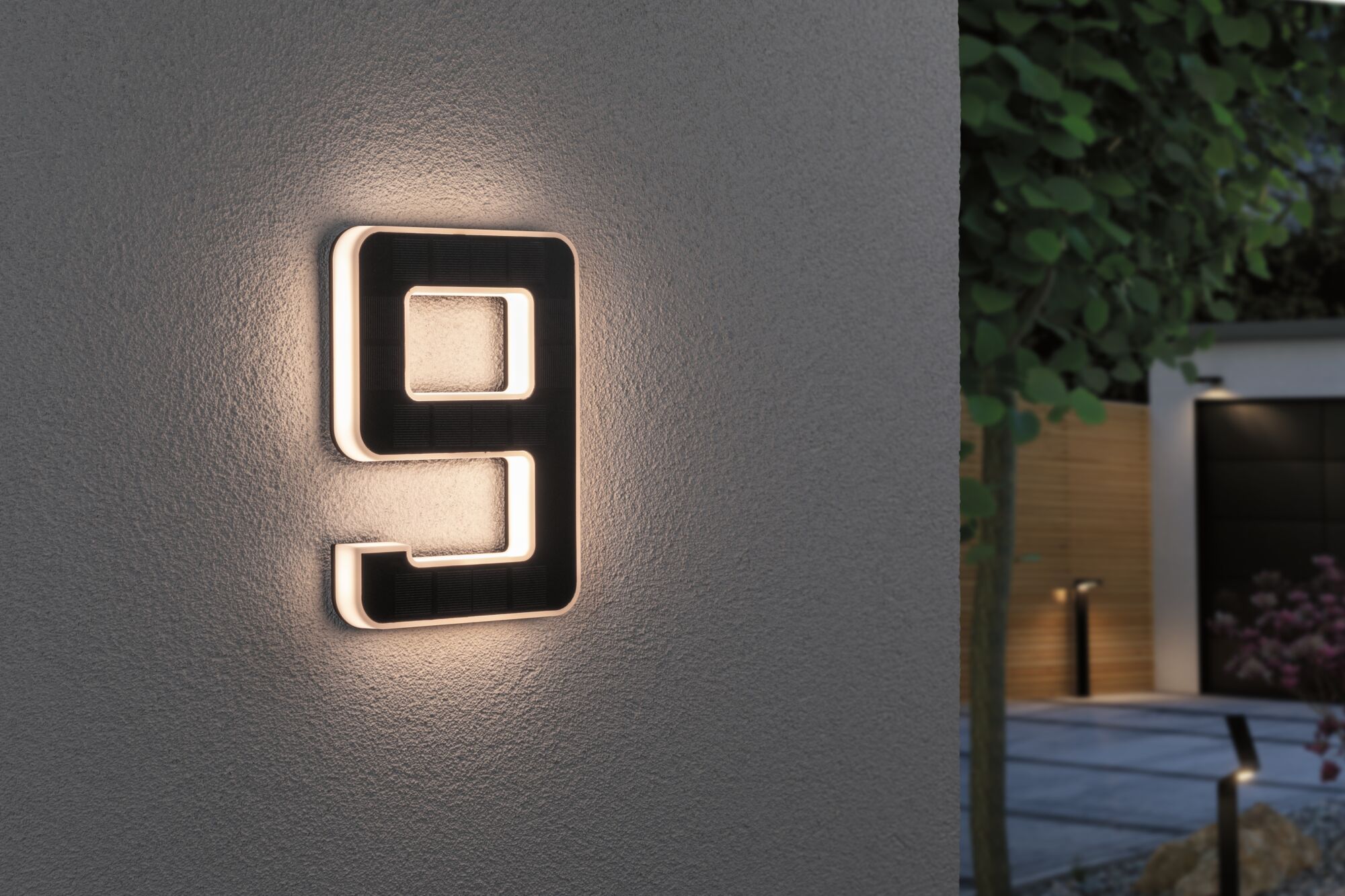 Modern black house number light with warm white LED edge on grey wall for outdoor lighting