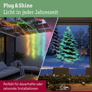 Bunte LED-Lichterketten an Holzbalken und beleuchteter Weihnachtsbaum im Wintergarten für saisonale Dekoration