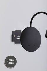 Black round metal wall lamp with flexible arm and magnetic mount for modern lighting solutions