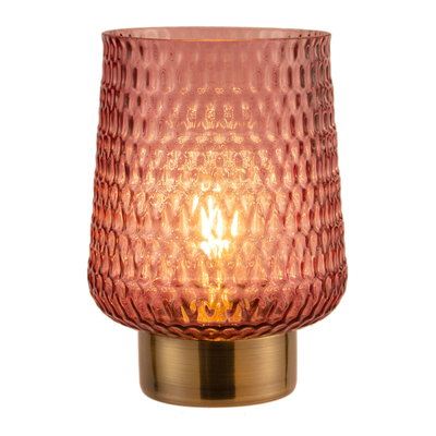 Pink textured glass table lamp with gold metal base providing warm ambient lighting for interiors