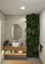 Salle de bain moderne avec plafonnier carré, meuble en bois et mur végétal vert.