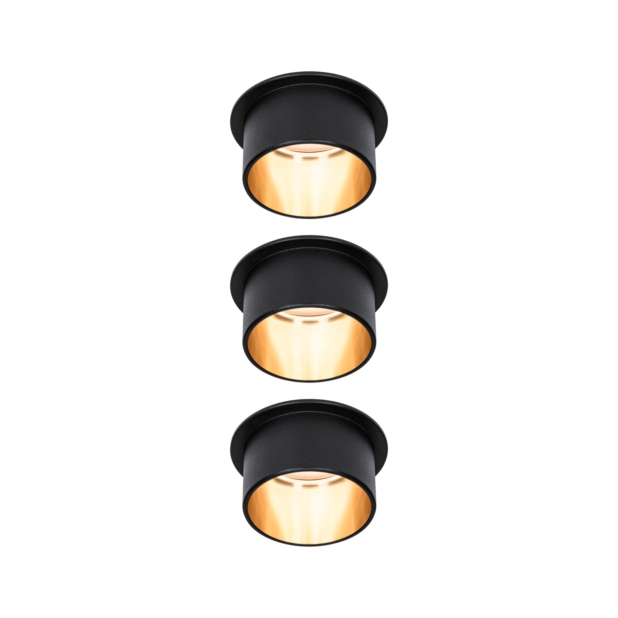 Trois spots encastrés noirs avec lumière blanche chaude pour un éclairage intérieur moderne.