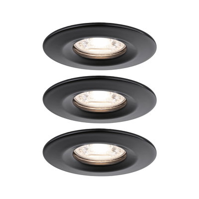 Three round recessed spotlights in matte black metal with warm white light for modern indoor lighting