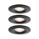 Three round recessed spotlights in matte black metal with warm white light for modern indoor lighting